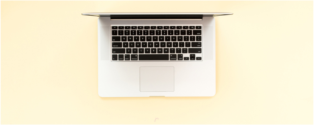 Inspirational Prompts for Christmas, woman drinking hot chocolate and writing in her journal with a candy cane as decoration
