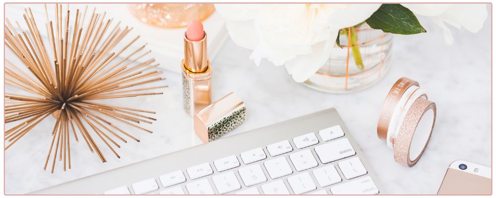 Inspirational Prompts for Christmas, woman drinking hot chocolate and writing in her journal with a candy cane as decoration