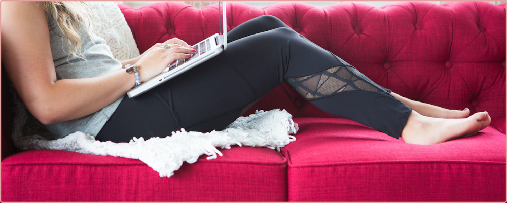 Woman stretching, wearing sage coloured yoga gears with sage water bottle for blog post 4 niching myths debunked