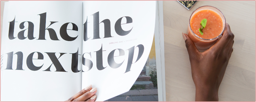 Inspirational Prompts for Christmas, woman drinking hot chocolate and writing in her journal with a candy cane as decoration