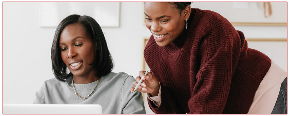 Woman at her desk being helped by her business coach