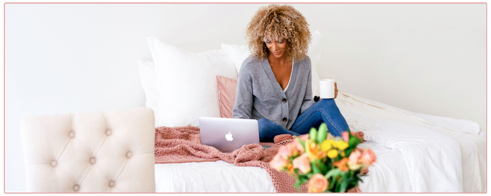 Inspirational Prompts for Christmas, woman drinking hot chocolate and writing in her journal with a candy cane as decoration